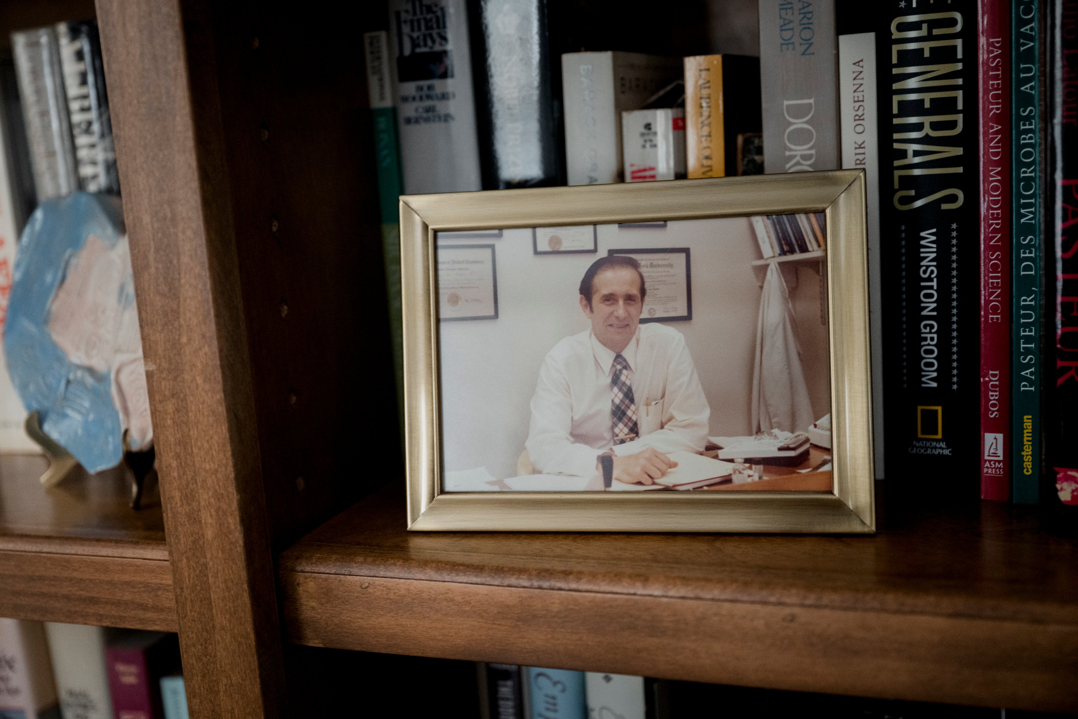 A framed picture of Plotkin sitting on a bookshelf