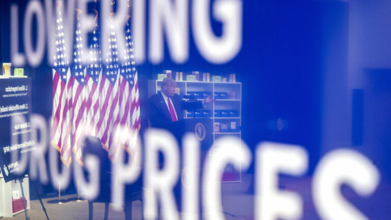 President Trump is reflected in a television monitor as he speaks during an event to sign executive orders on lowering drug prices in July 2020.