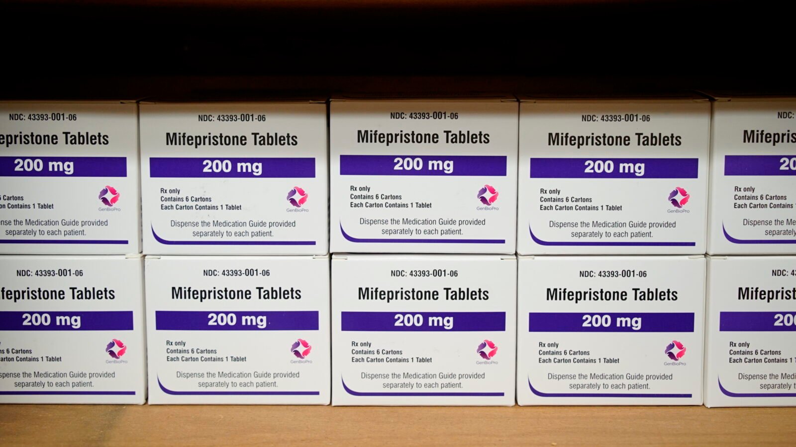 Stacks of small white boxes of mifepristone (200 mg) lined up on a shelf
