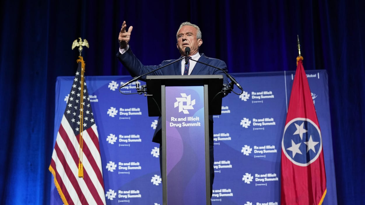 Robert F. Kennedy Jr. stands at a podium on stage at the Rx and Illicit Drug Summit in April in Nashville, Tenn.