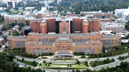 Aerial_view_of_the_Clinical_Center_Building_10_NIH_Campus_Bethesda_MD_20384488641-1600x900 (1)
