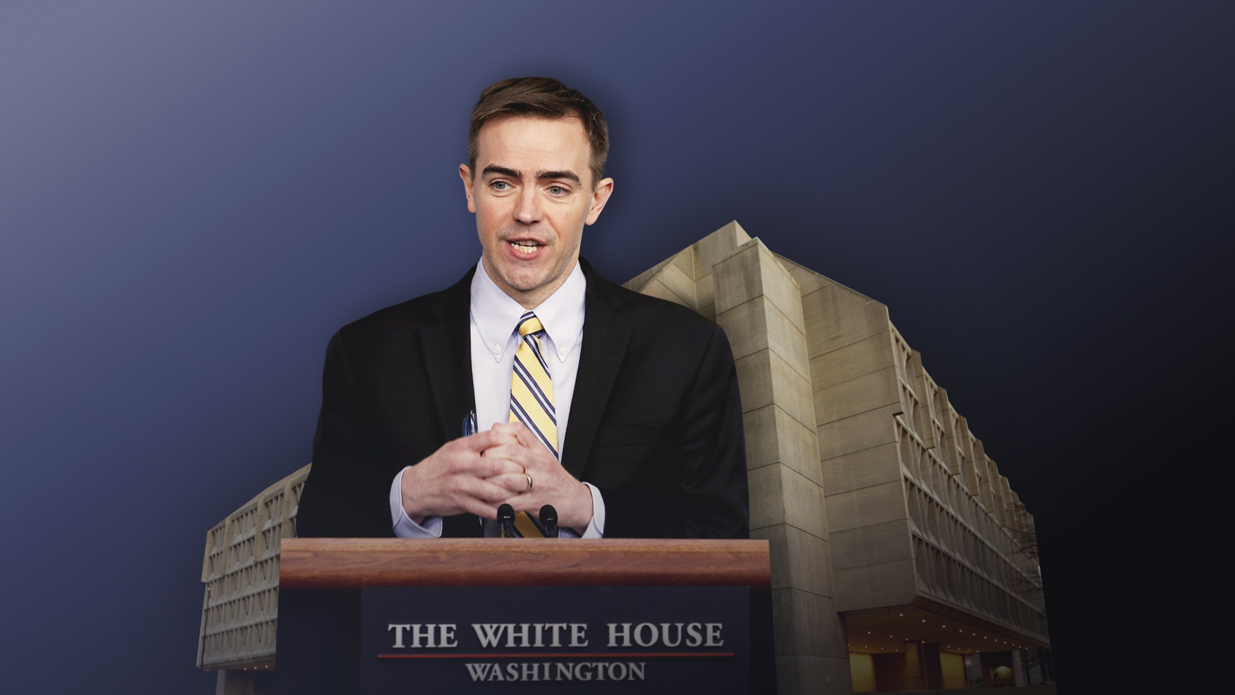 Brad Smith stands at a podium with his hands gripping each other tightly over it.