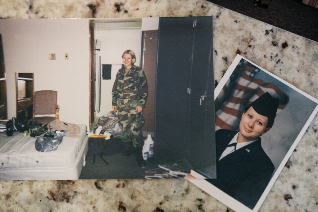 Two photographs of Hollitt from her time in the Air Force sit on the counter. In one she stands in fatigues next to a messy bed. The other is an official portrait.