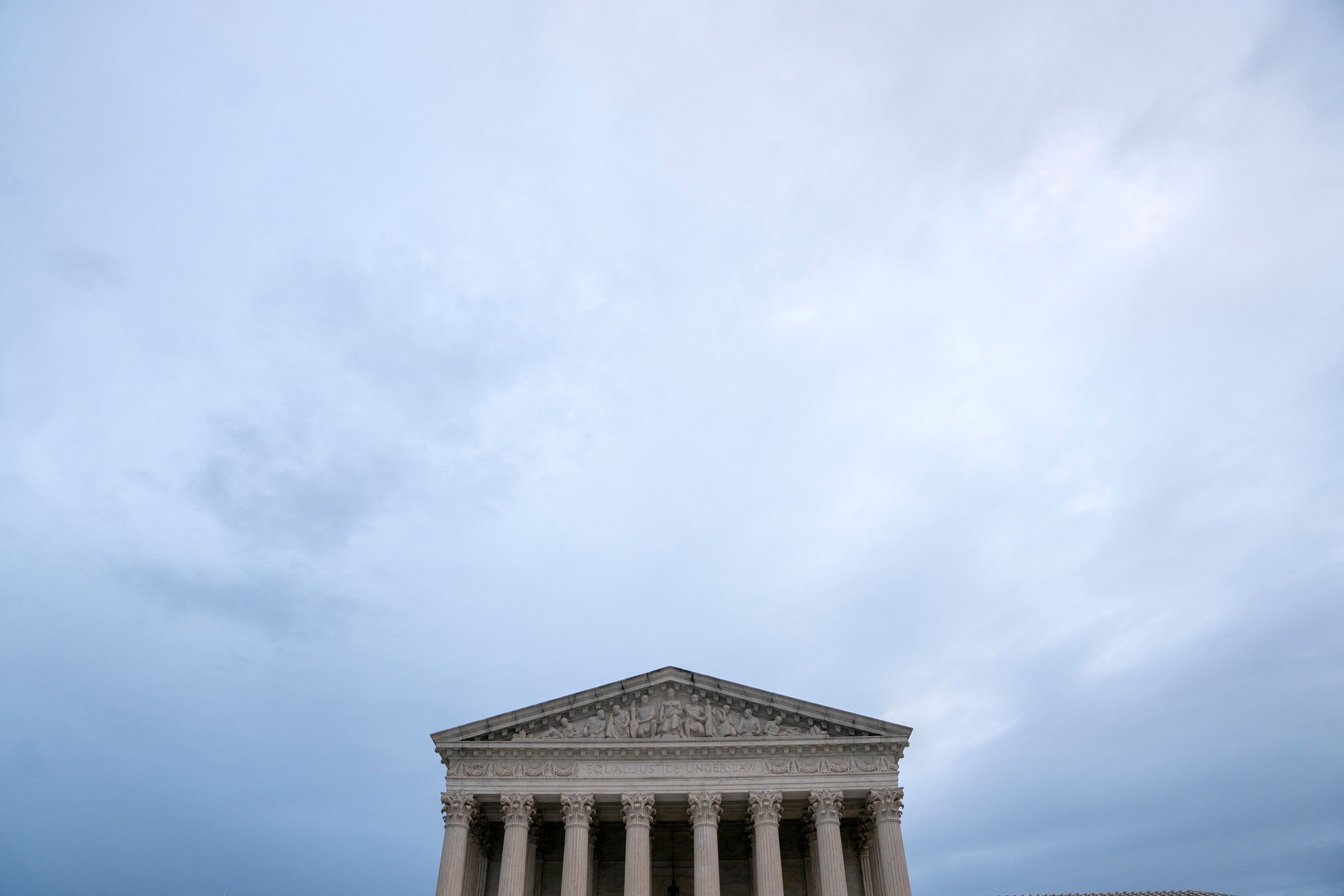 The US Supreme Court building on a cloudy day.