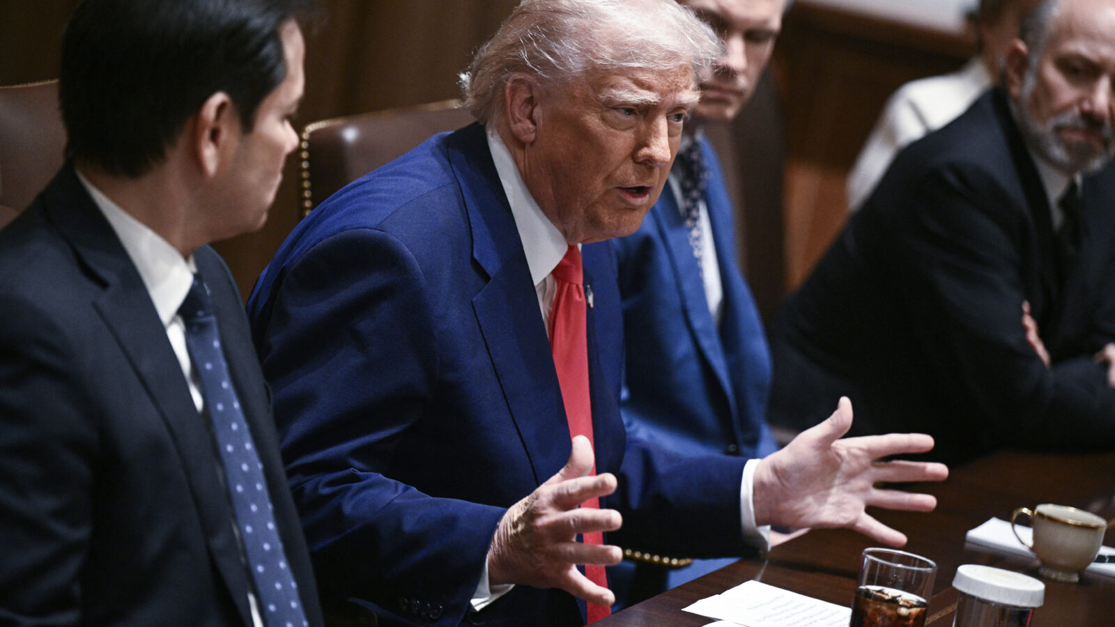 President Trump talks with his hands at a cabinet meeting.