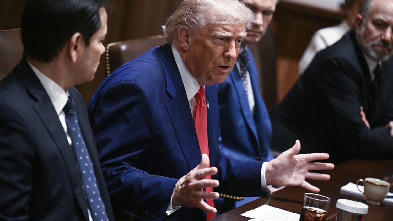 President Trump talks with his hands at a cabinet meeting.