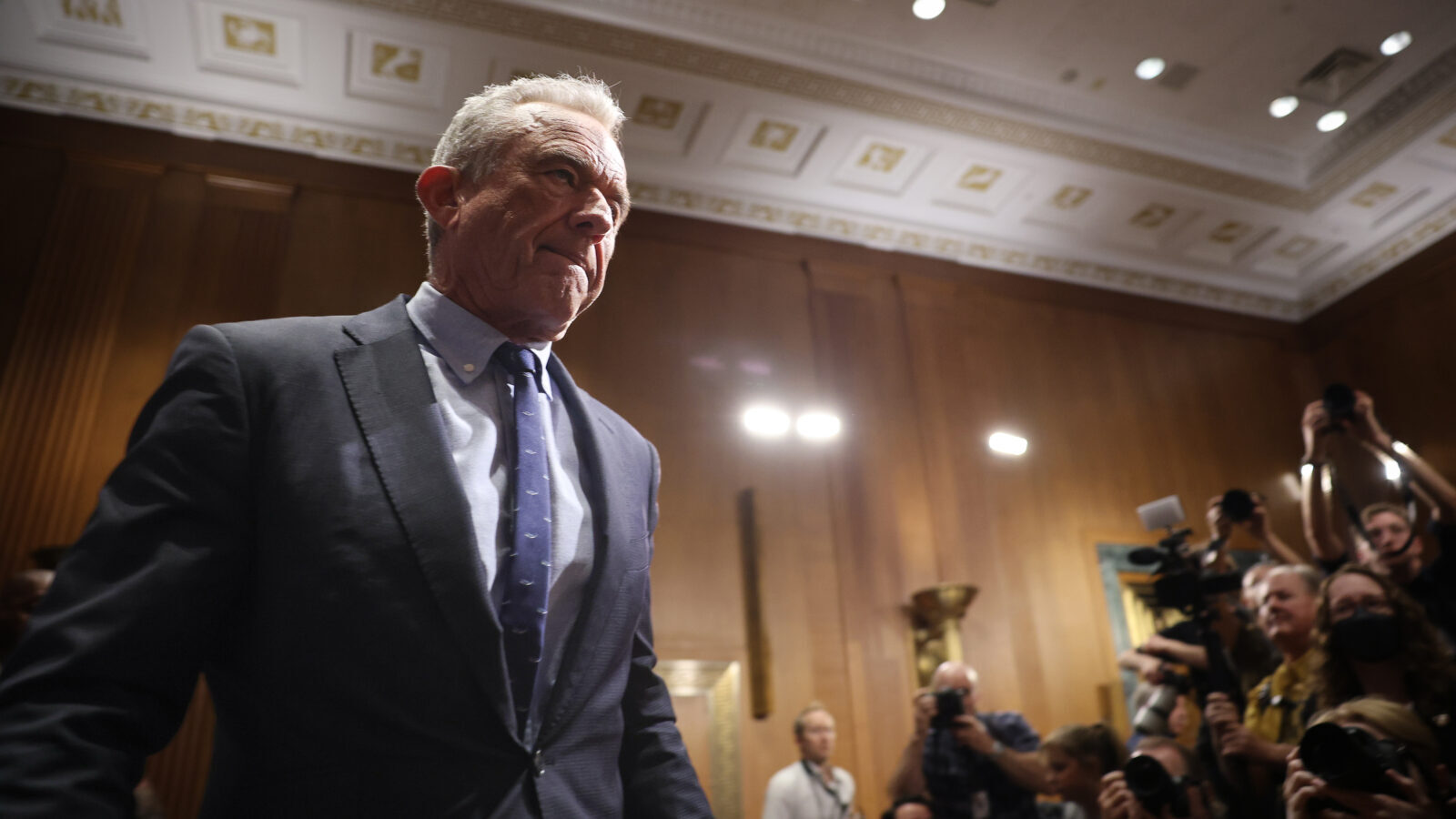 Robert F. Kennedy Jr., appearing before the Senate Finance Committee last week, looks serious with a shadow over his face