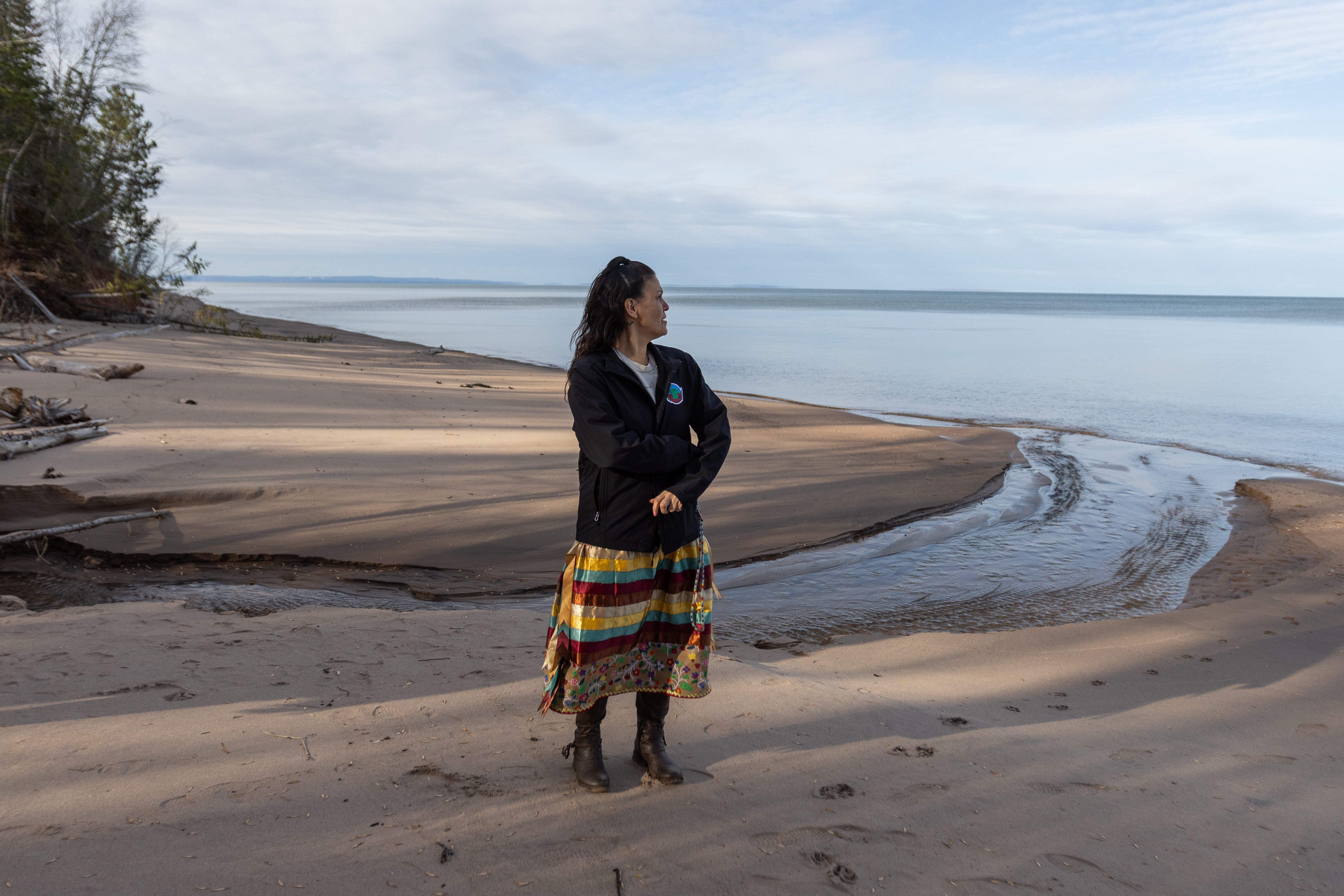 Lisa Whitebird stands on the south shore of Lake Superior on the Bad River Reservation in Wisconsin.