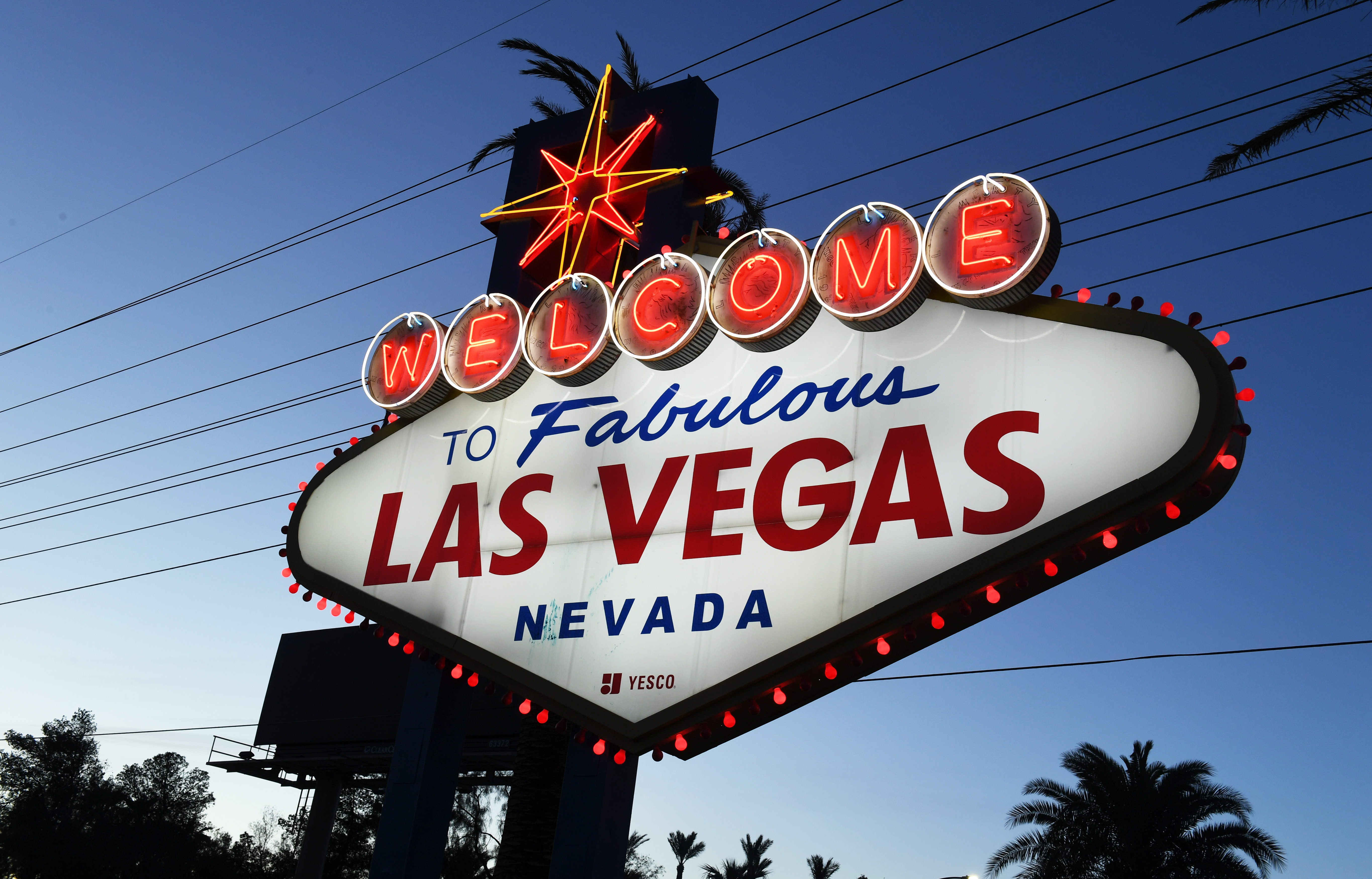Red lights flicker around the Welcome to Fabulous Las Vegas sign.