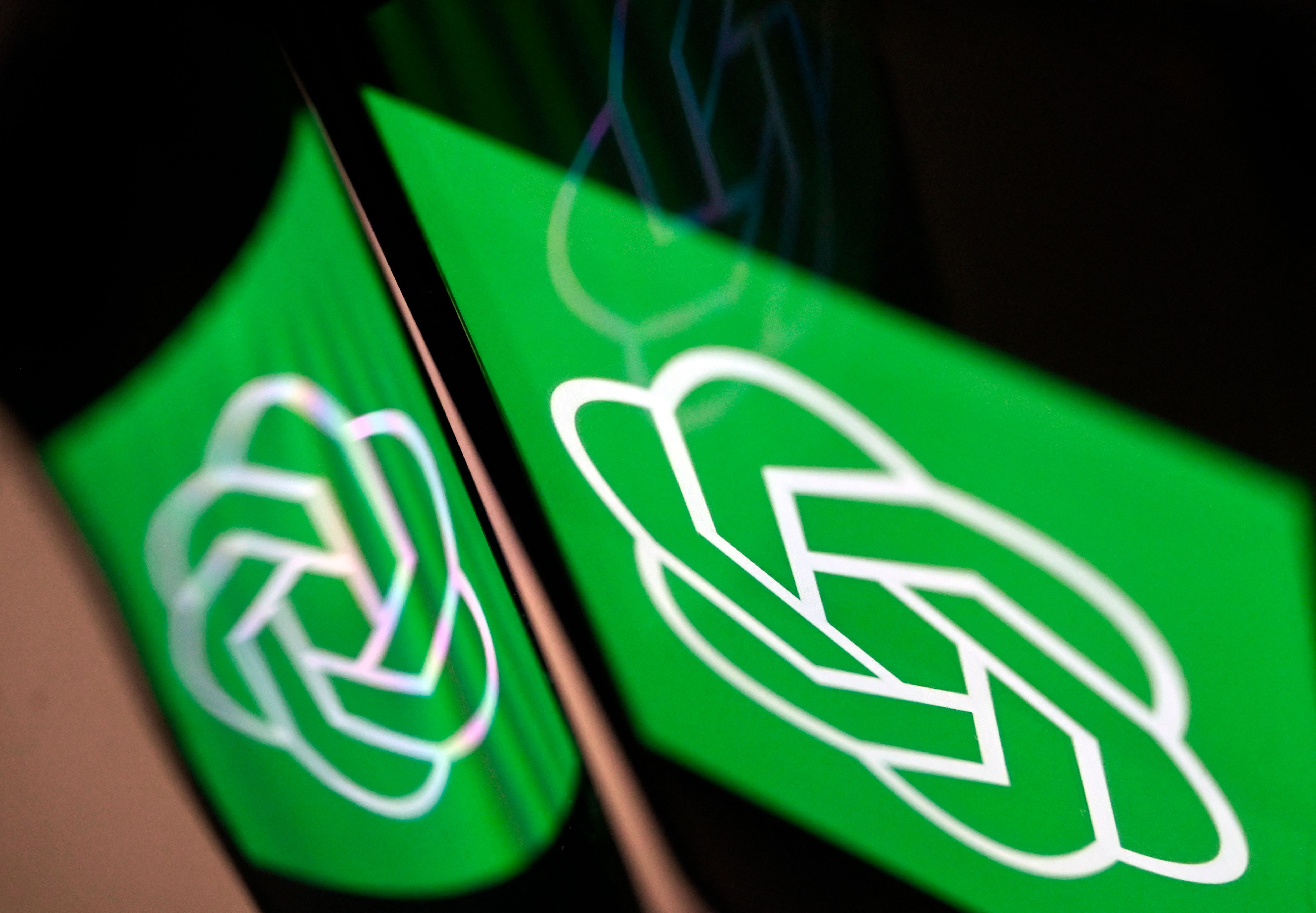 OpenAI logo reflected to another surface from a phone screen