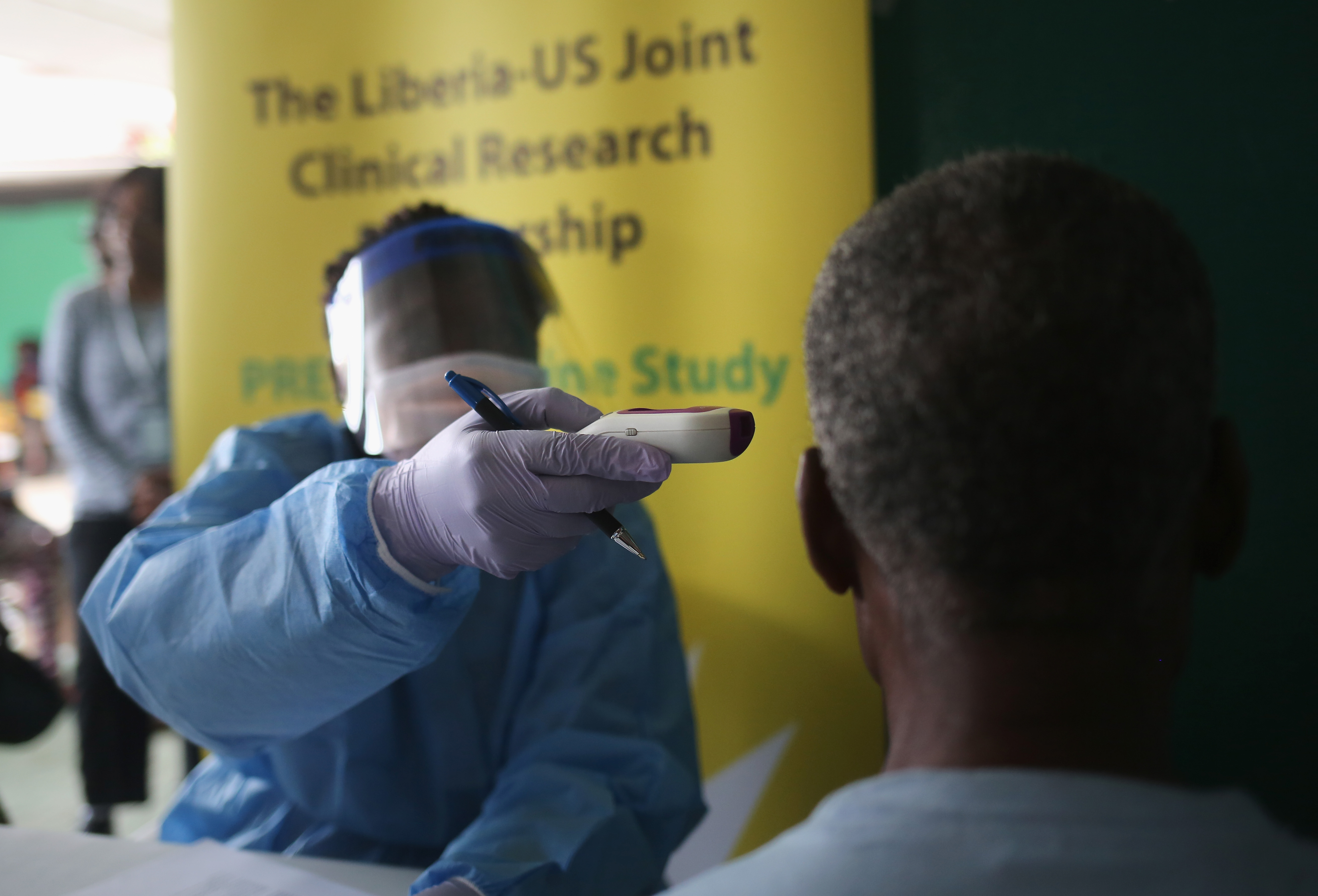 A nurse takes the temperature of a participant in the Ebola vaccine trials