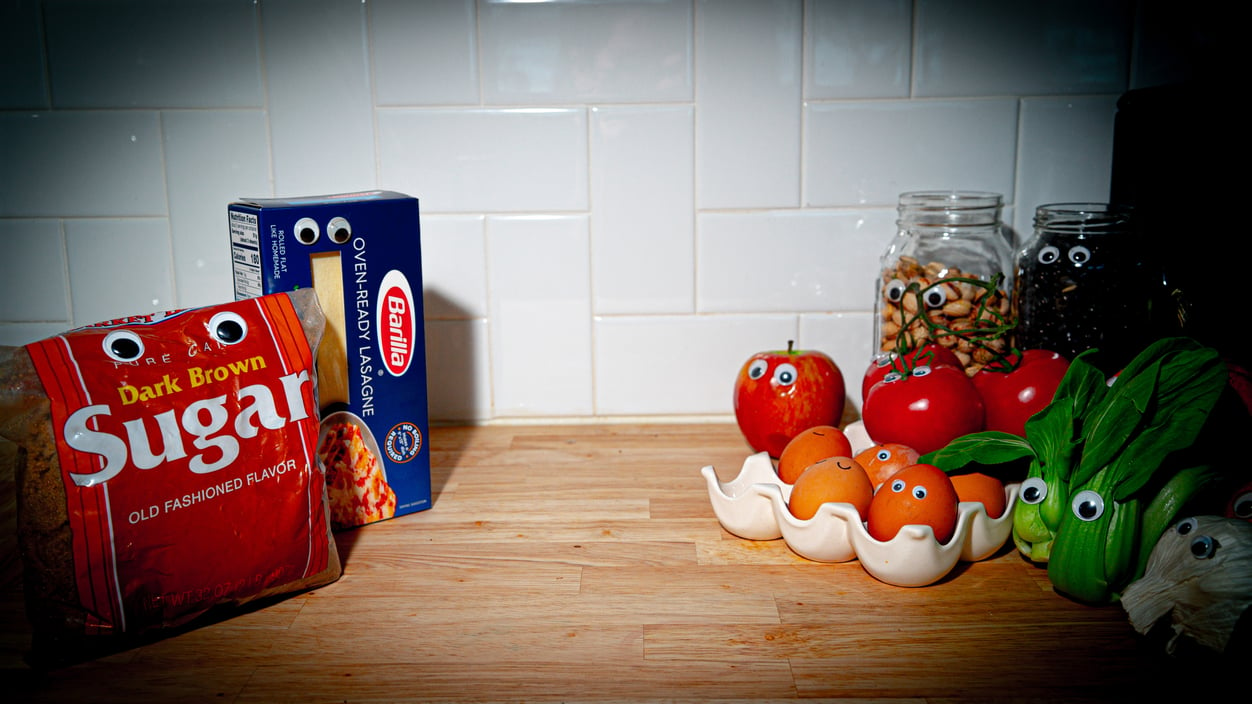 photo illustration of healthy and unhealthy foods facing off, with googly eyes