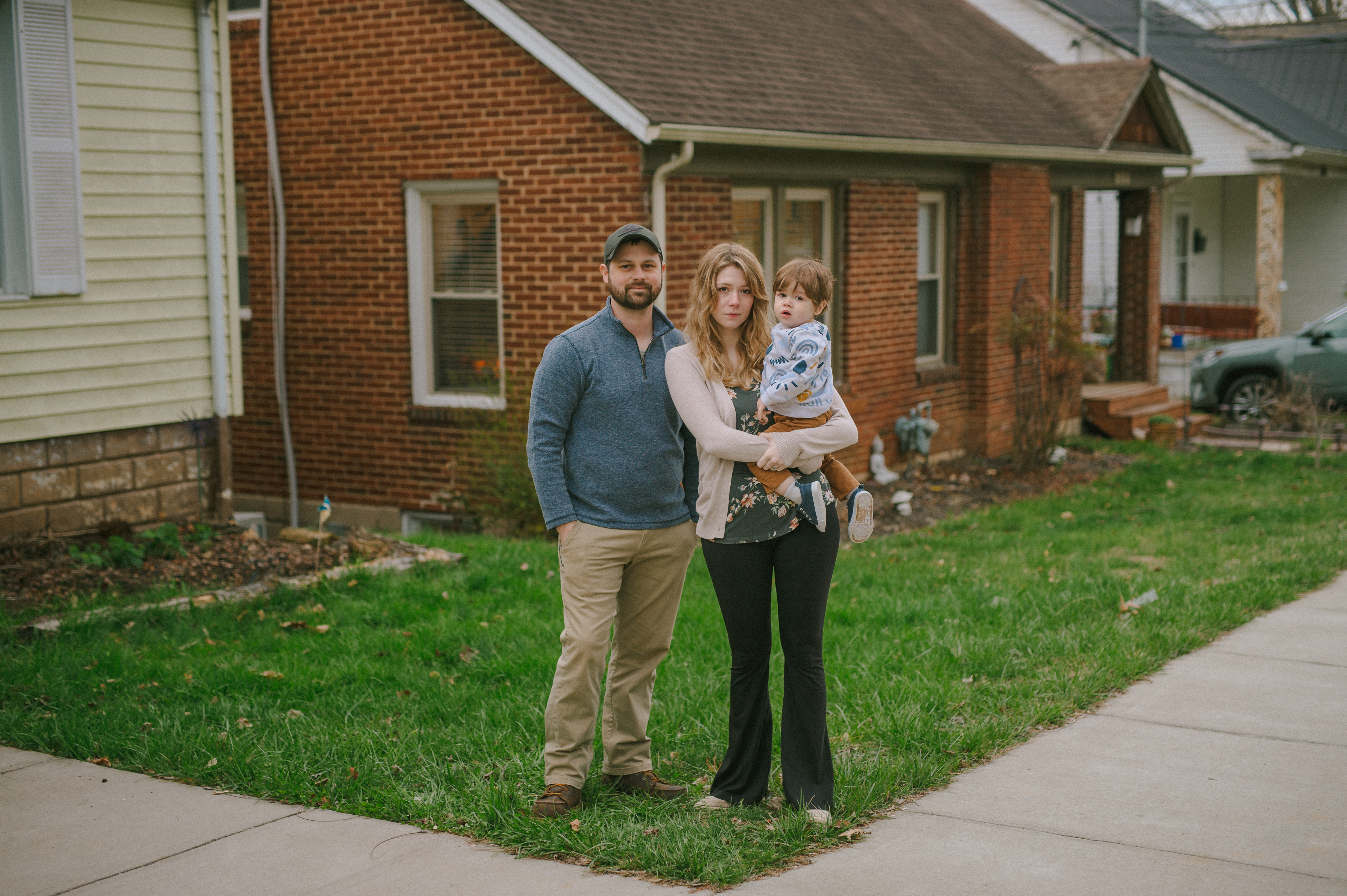 Tim and Zoe Poplin pose for a portrait with their toddler, Ezra outside of their home in Bristol, Tennessee.