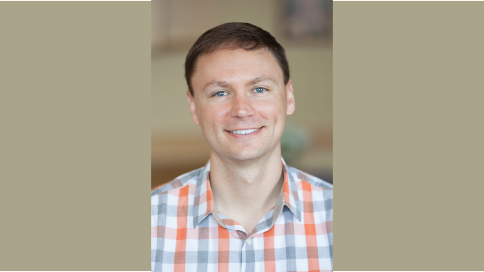 A vertical portrait of Scott Delaney smiling is layered on a khaki background 
