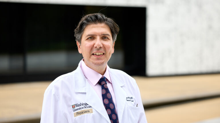Ziyad Al-Aly, clinical epidemiologist at Washington University, stands in a medical coat and tie