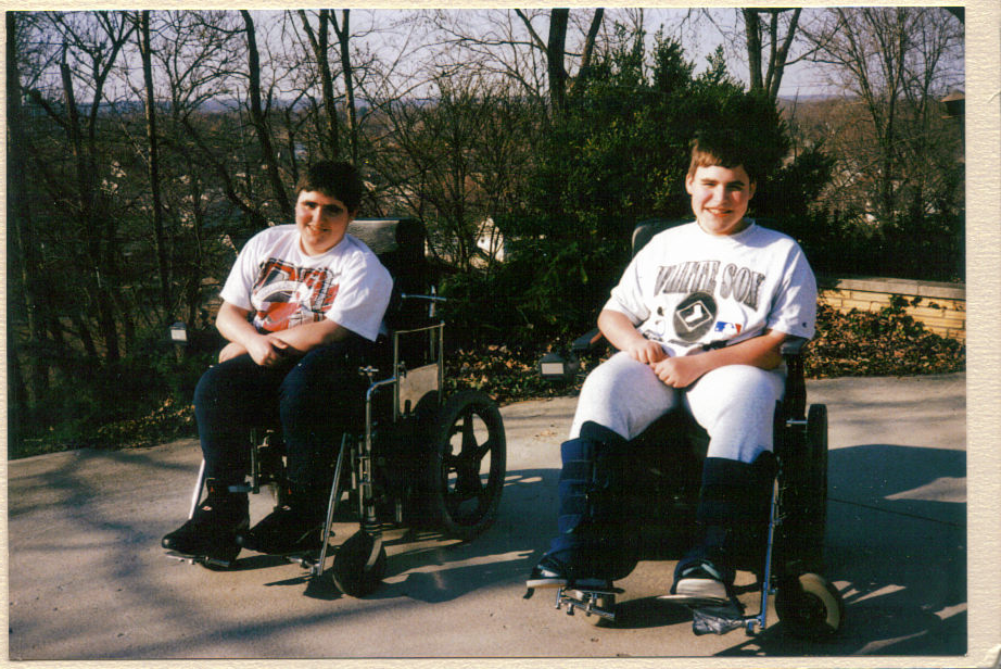 Patrick and Christopher Furlong sit in their wheelchairs outside.